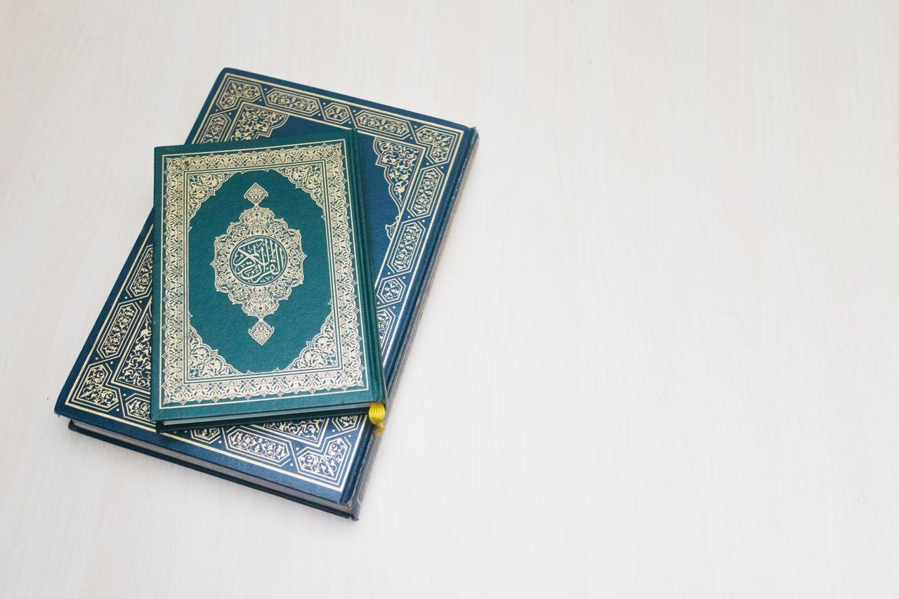 services-04 Top view of ornately decorated Quran book cover on a white background.