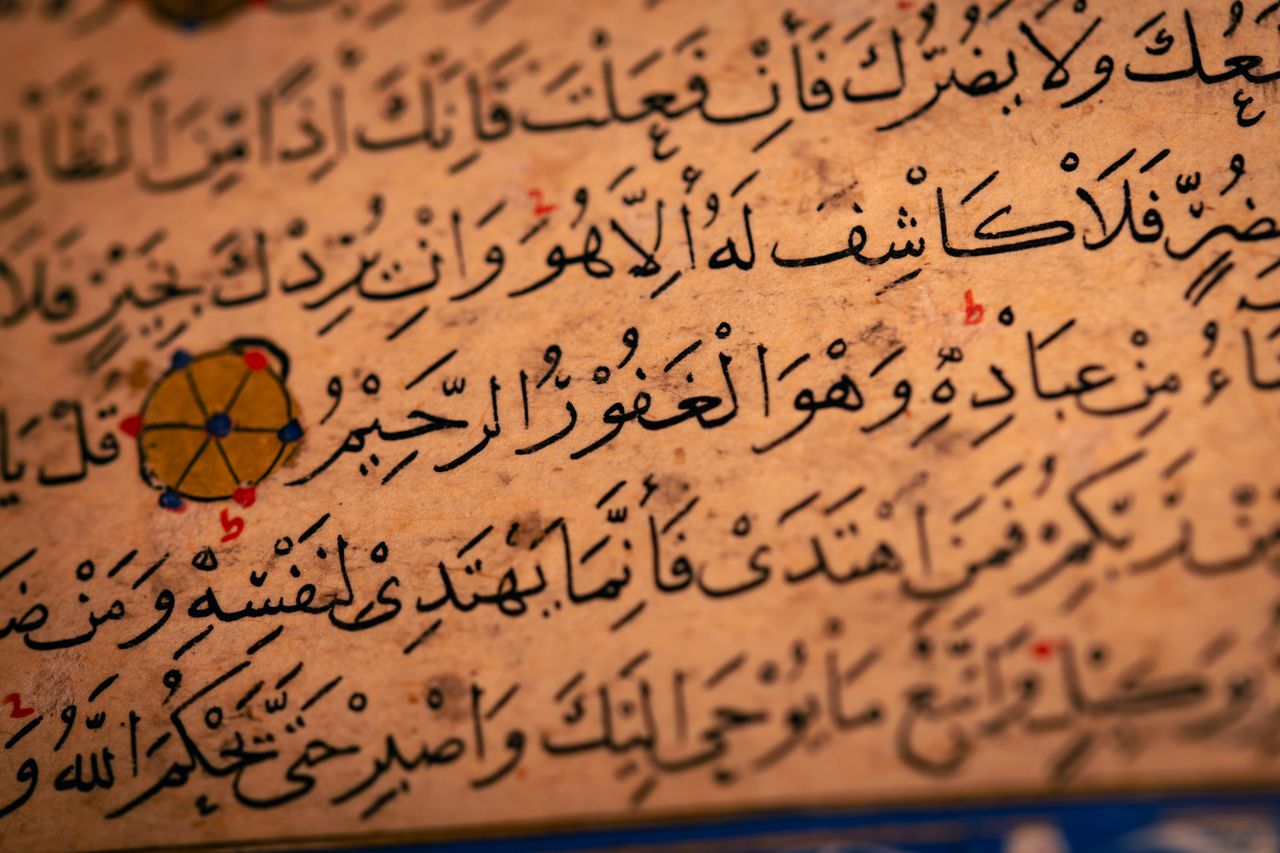 journey-02 Detailed close-up of Arabic calligraphy on an ancient manuscript, showcasing historical text.