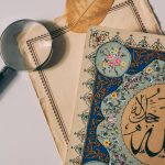 The Art of Drawing Readers In: Your attractive post title goes here Elegant flat lay with Arabic calligraphy and magnifying glass on vintage paper.