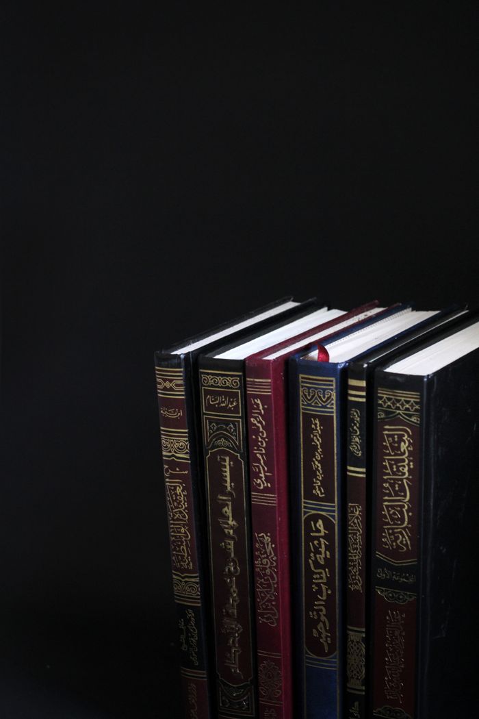 vision A collection of Arabic books arranged vertically on a black background.
